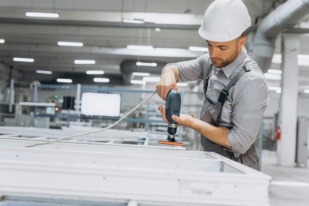 Aluminium and PVC industry worker making PVC or aluminium frames for windows and doors